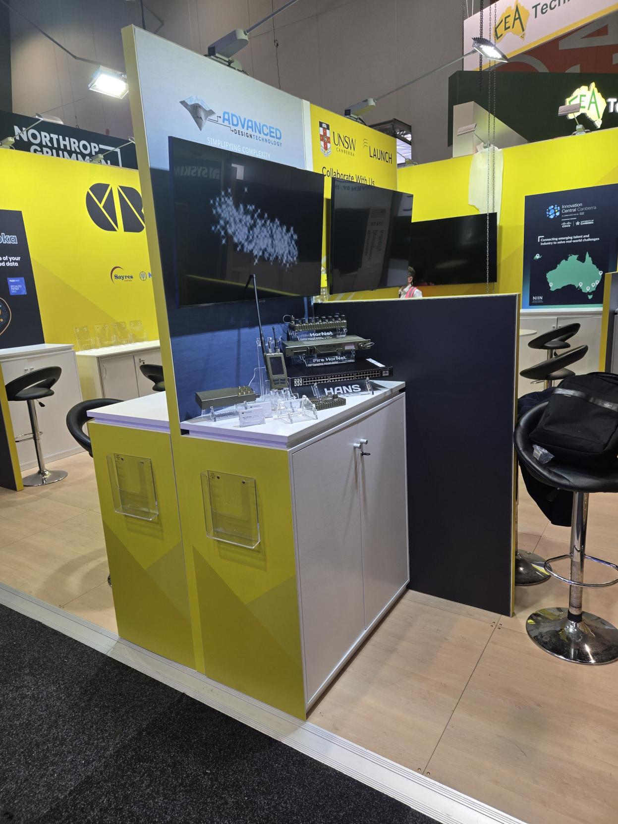 The Advanced Design Technology stand at Land Forces, with the HorNet, Fire HorNet and HANS secure-computing products on display beneath the ADT 'Simplifying Complexity' banner